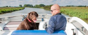 A man and his dog on a boating holiday